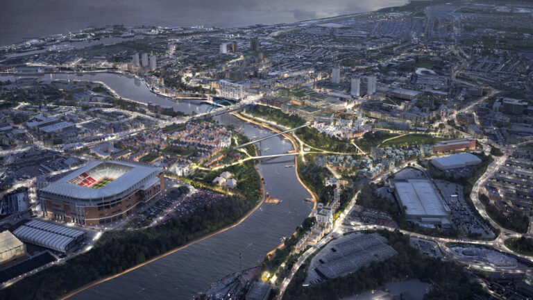 Aerial view of Sunderland, U.K., at night with illuminated football stadium, roads and bridges.