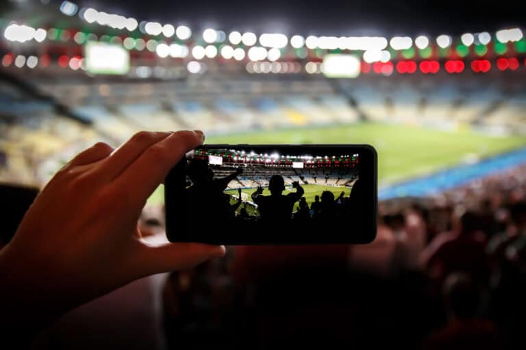 Looking at a smartphone image of a soccer stadium at night.