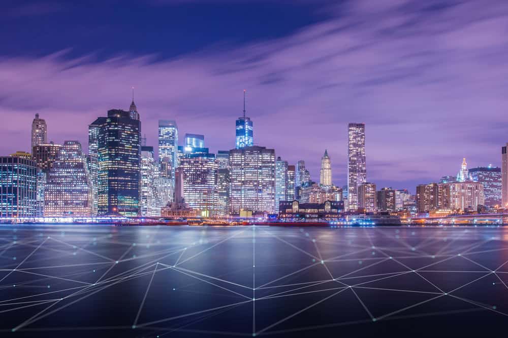 Night view of city skyline with connected dots overlay in foreground.