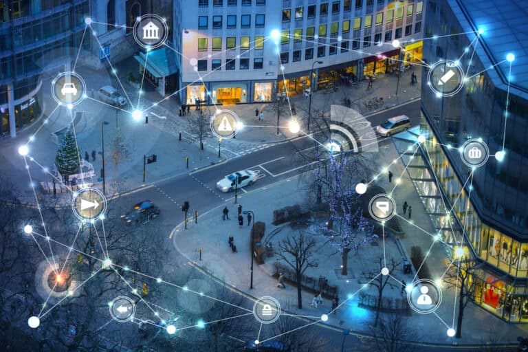 Aerial image of City of London road intersection with connected dots and icons overlay.