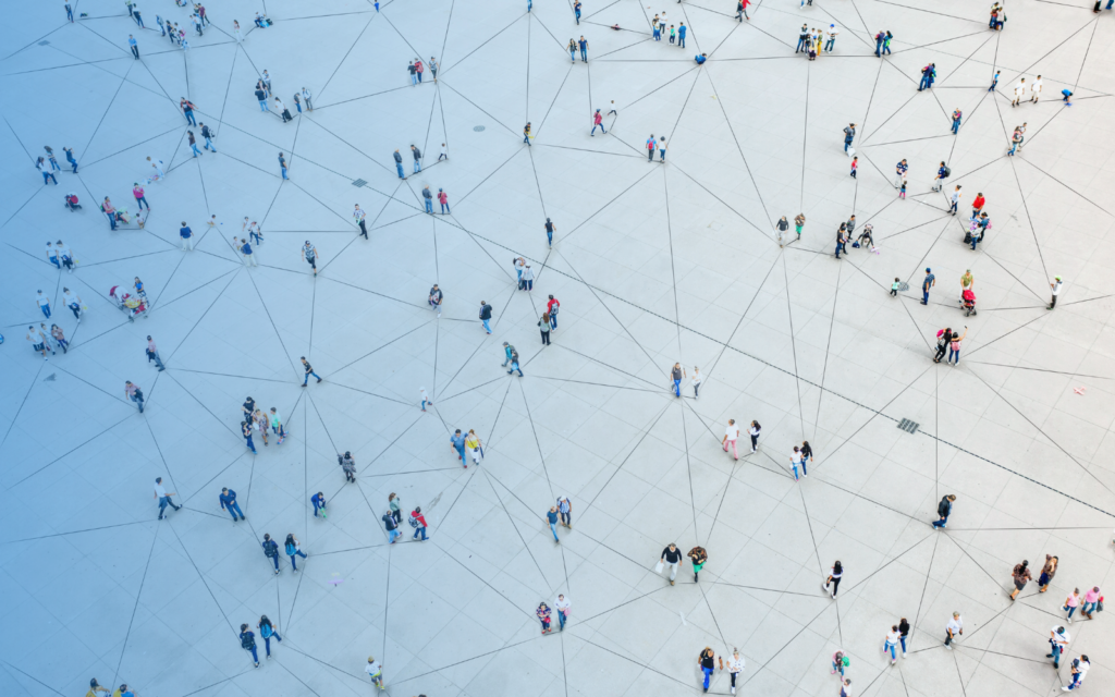 Aerial image of people walking across an open public square.