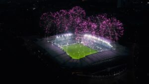 Aerial establishing shot of a whole stadium with fireworks.
