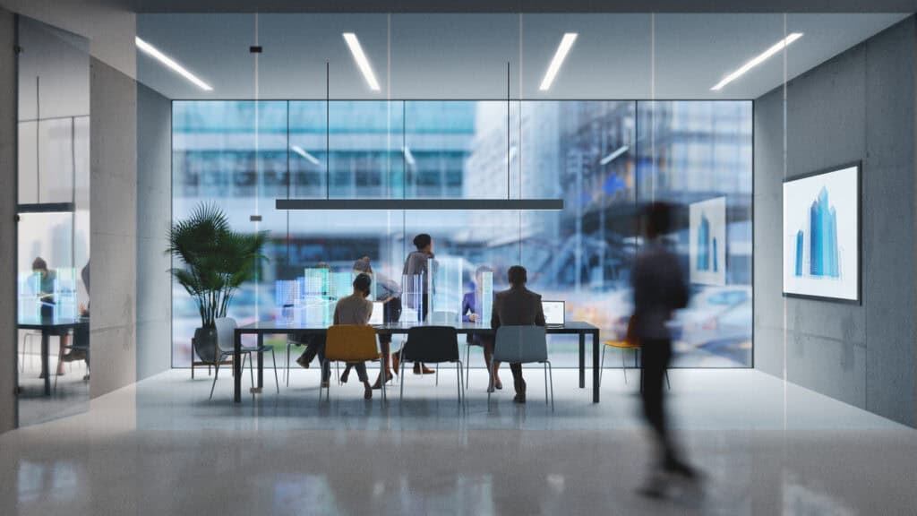 Glass office meeting room with city buildings in background.