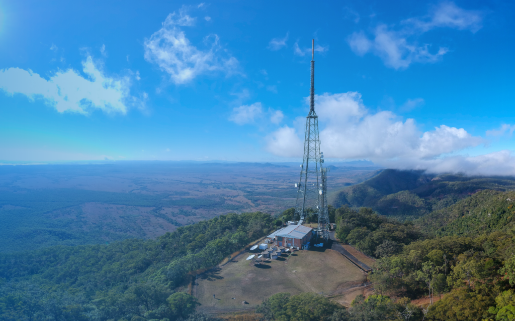 Image of a broadcast tower on a mountain top.