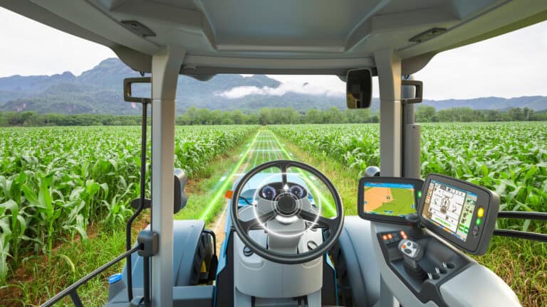 5G autonomous tractor working in a corn field.