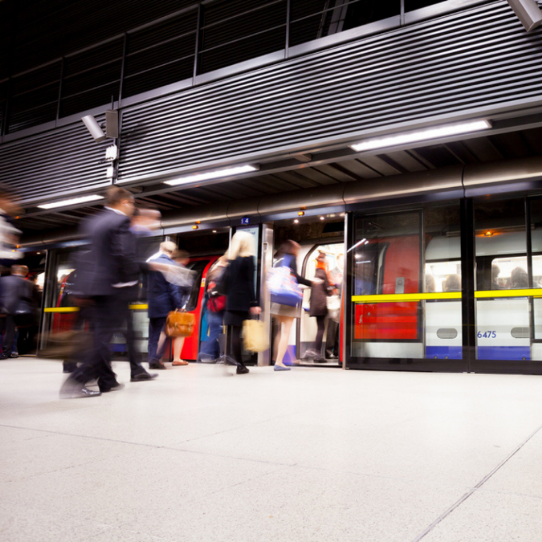 Passengers get on the London Underground.