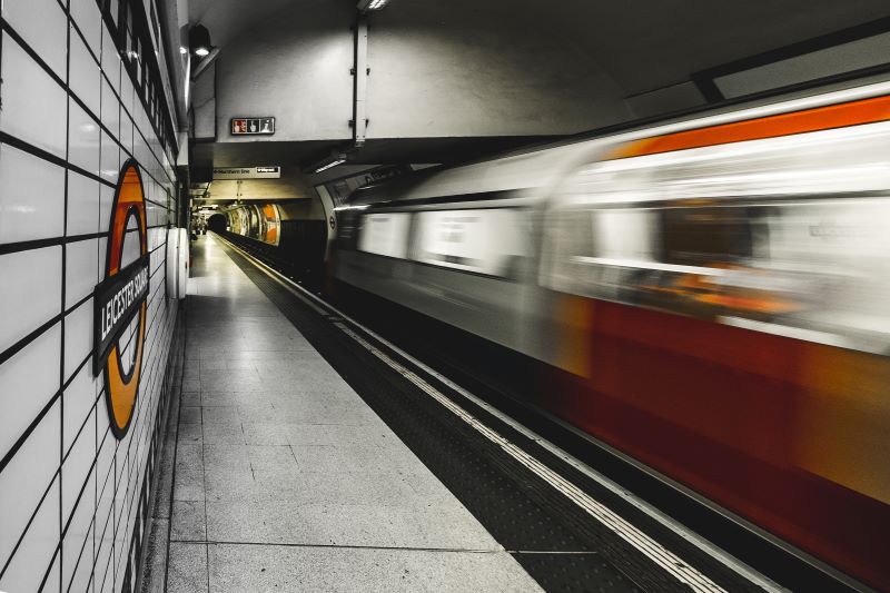 Motion blurred training leaving Leicester Square tube station.