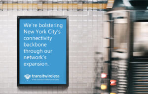 Transit Wireless poster a subway train platform. "We're bolstering New York City's connectivity backbone through our network's expansion."
