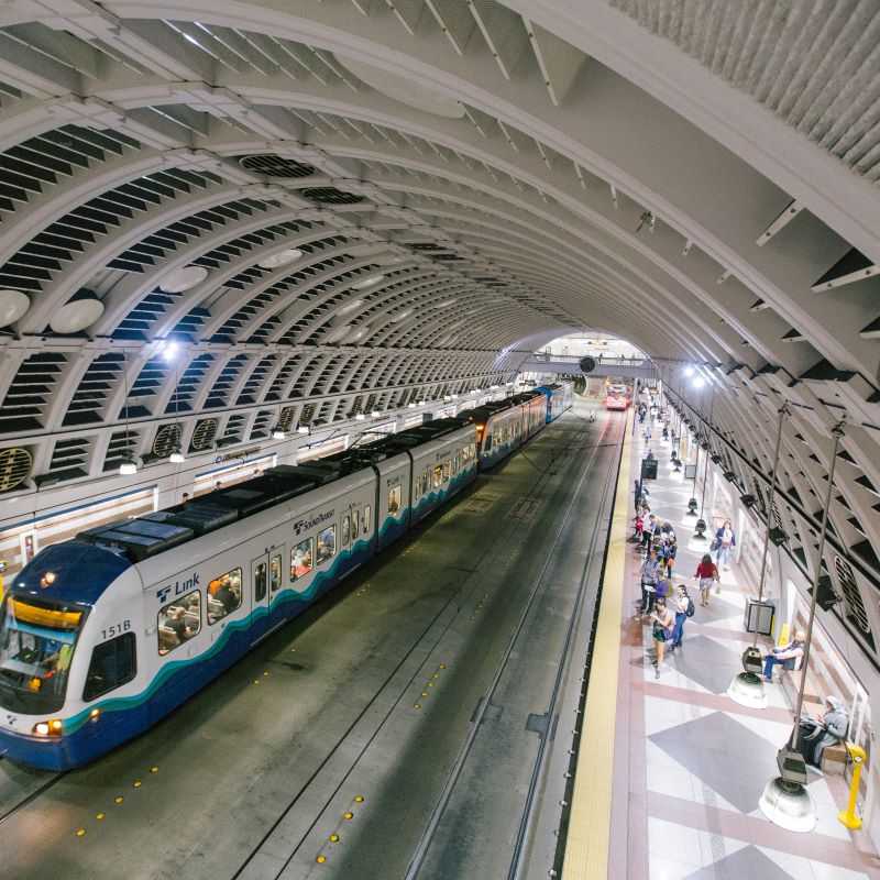 View of a train at a station platform with a white domed roof.