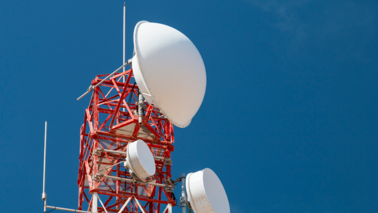 Transmission tower with dishes at the top.