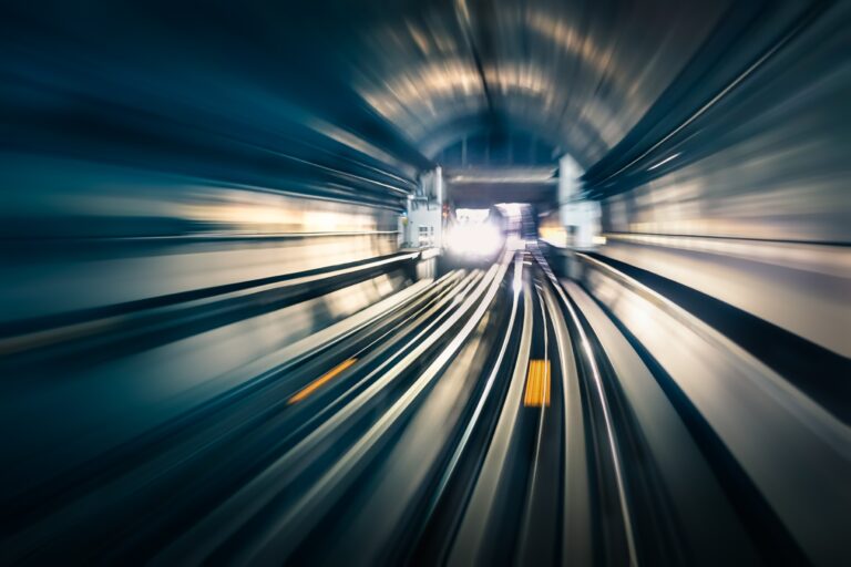 Motion blurred view of train tunnel.