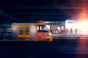 Sydney city railway platform as train passes at speed.