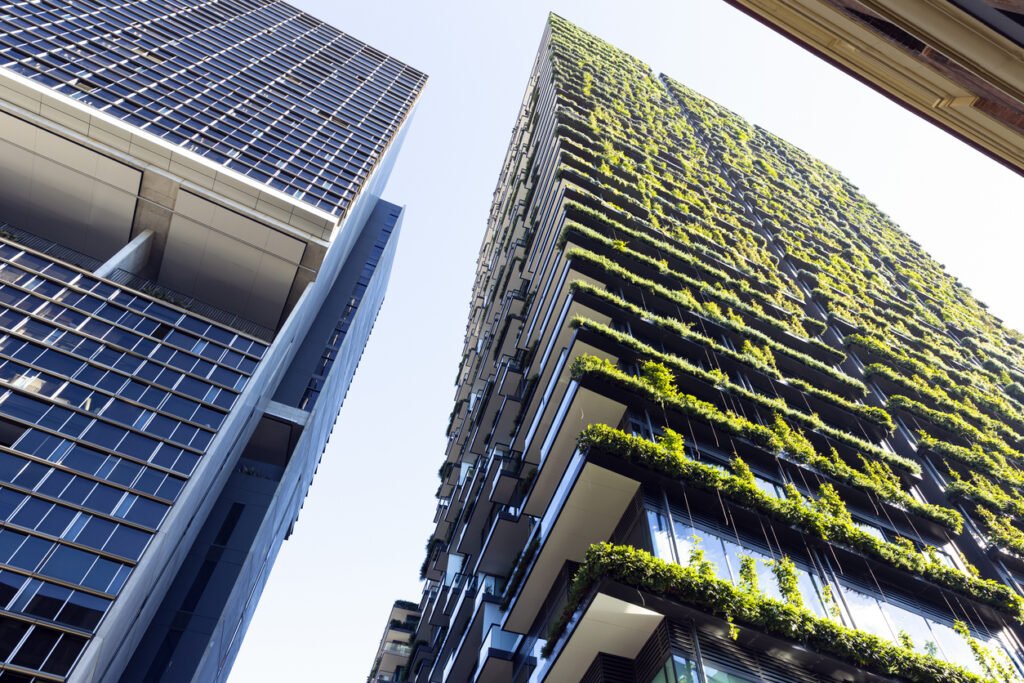 Low angle view of apartment building with vertical garden, sky background with copy space, Green wall-BioWall or living wall is a wall covered with living plants on residential tower in sunny day, Sydney Australia.