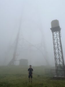 Ben a BAI Broadcast Technician pictured at a foggy broadcast tower.