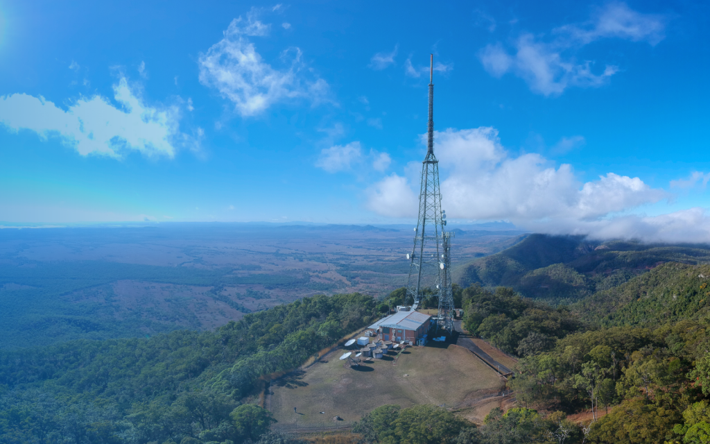 Image of a broadcast tower on a mountain top.